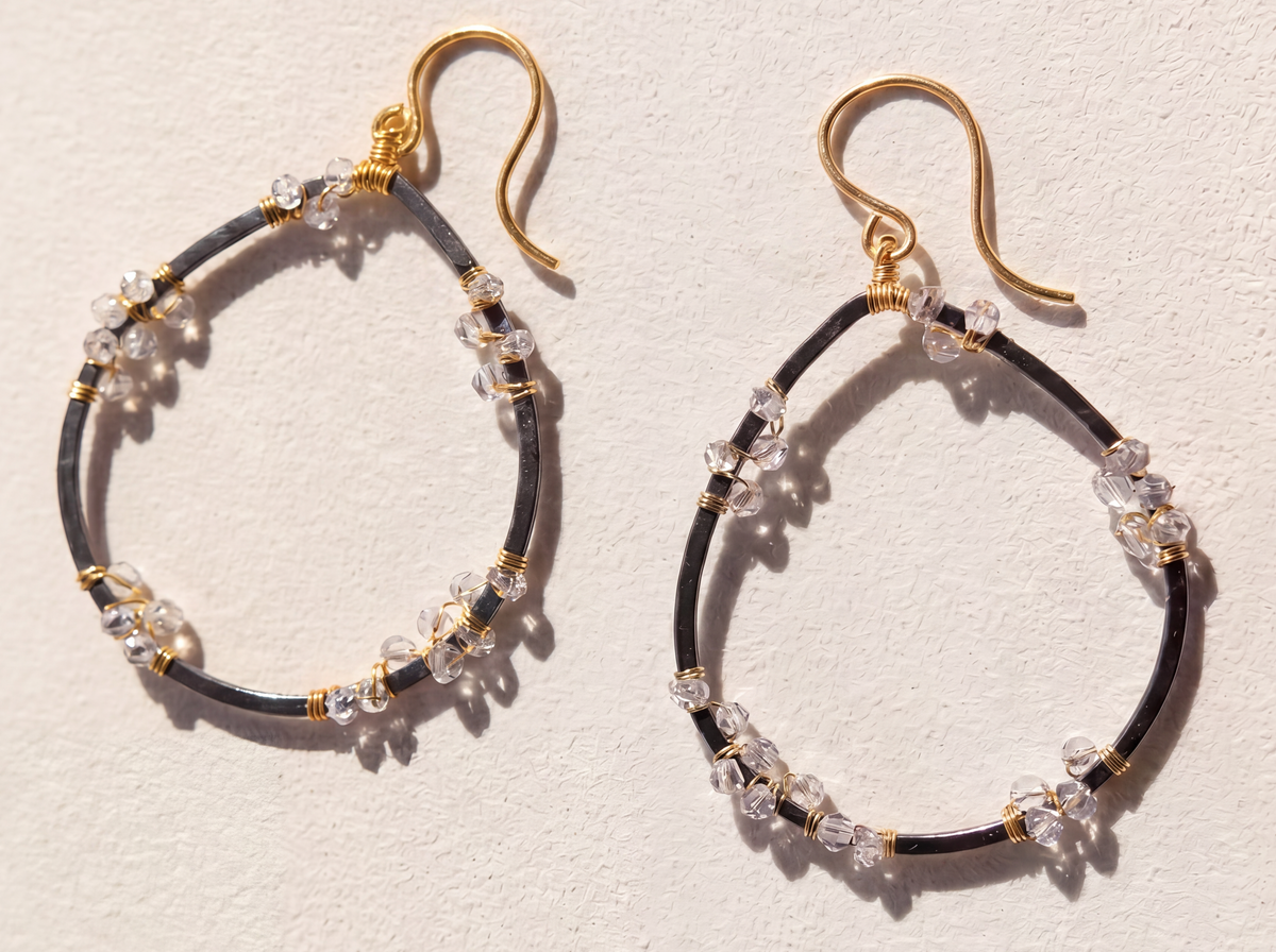 Gold-tone teardrop hoop earrings with clear crystal beads and gold hooks