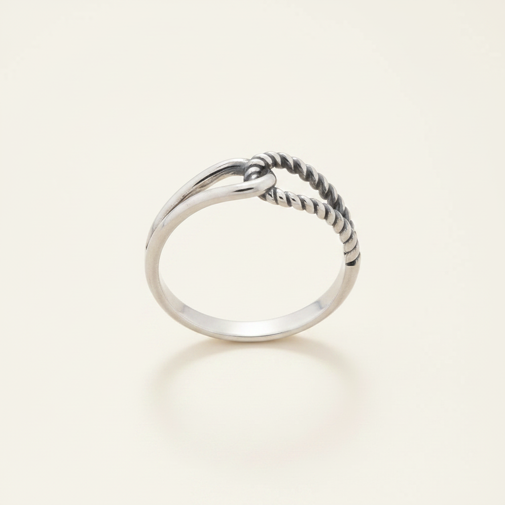 Silver-tone interlocking loops ring, twisted loop across top of polished band