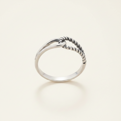 Silver-tone interlocking loops ring, twisted loop across top of polished band