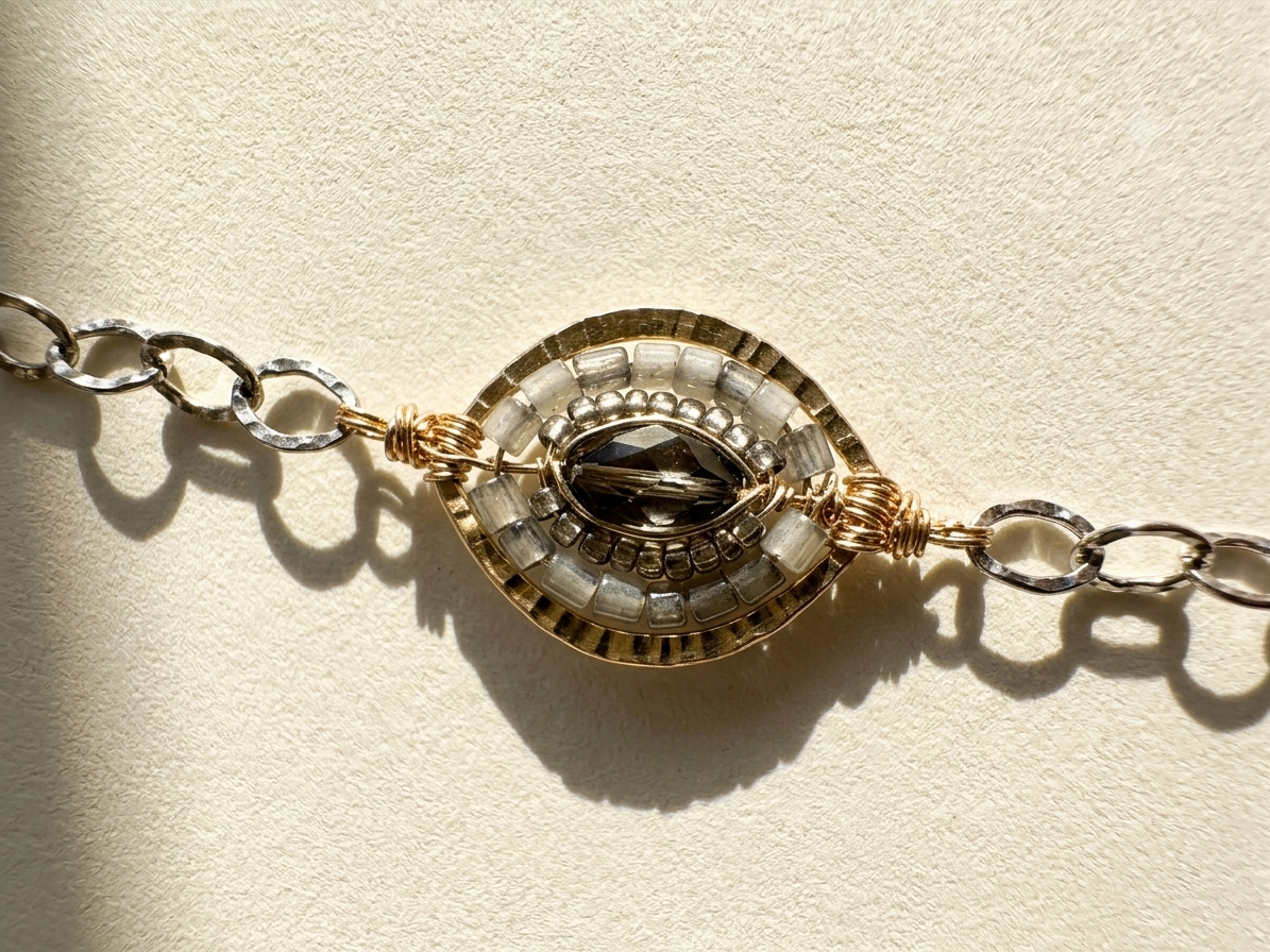 Medallion chain bracelet with round gold-and-silver centerpiece and linked clasp