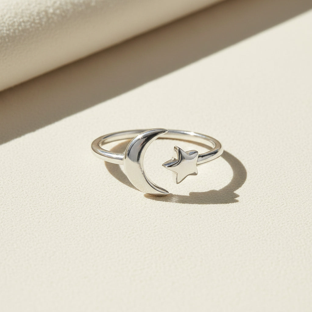 Silver-tone ring with moon and small star charm design, slim band