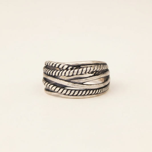 Silver ring with braided design on a white background
