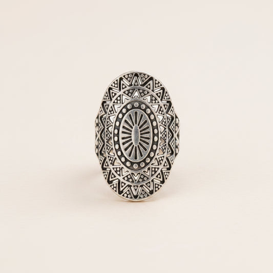 Silver ring with intricate geometric design on a white background