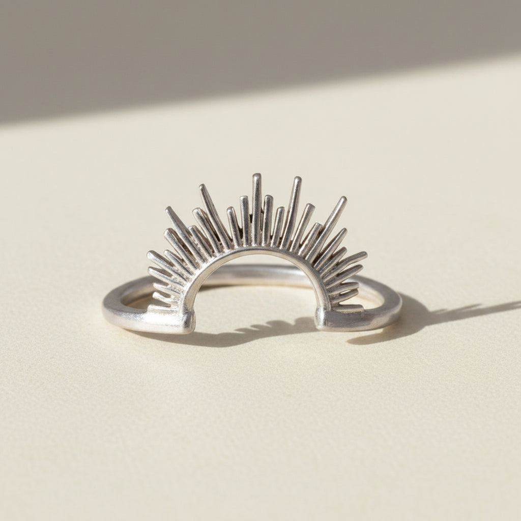 Sunrise ring, silver-tone open band with radiant sunburst rays.