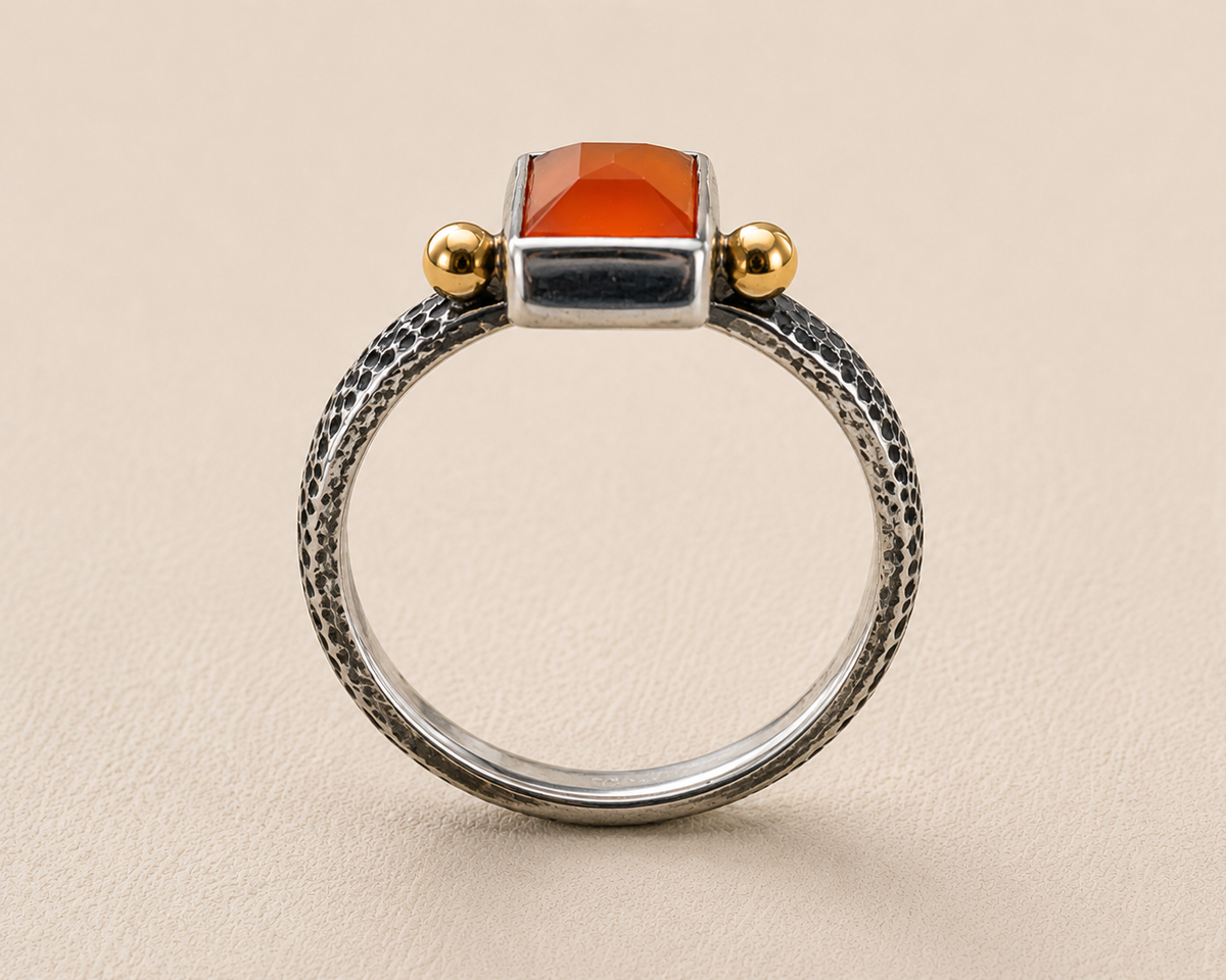 Front view carnelian orange stone ring with textured silver hoop and gold top posts