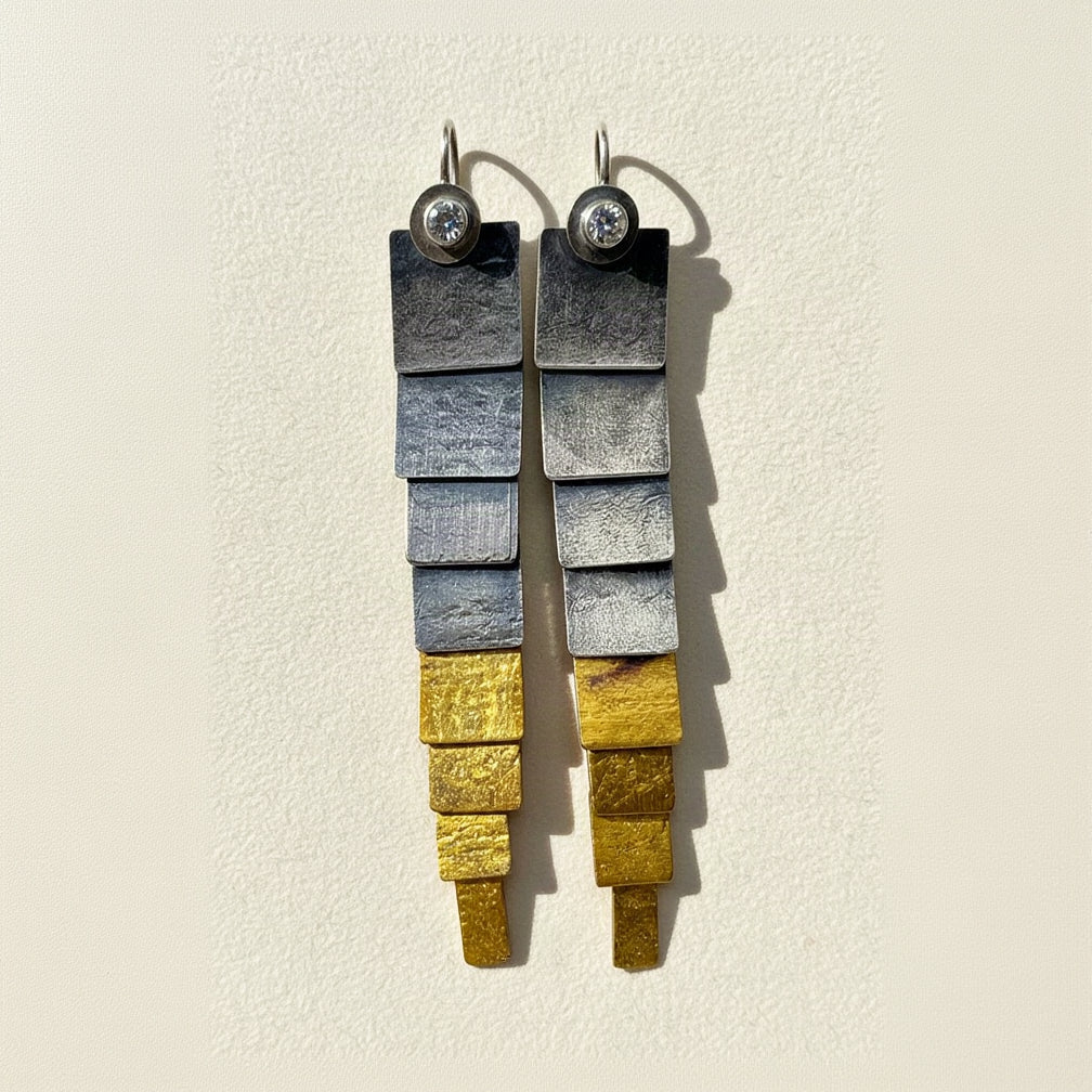 Silver and gold stacked-rectangle drop earrings with round stud tops.