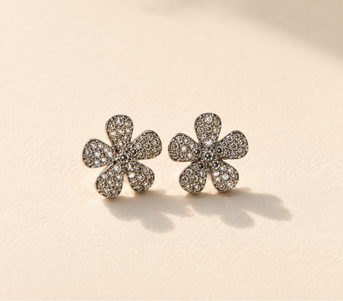 Pave diamond flower stud earrings with six-petal design