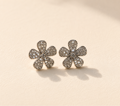 Pave diamond flower stud earrings with six-petal design