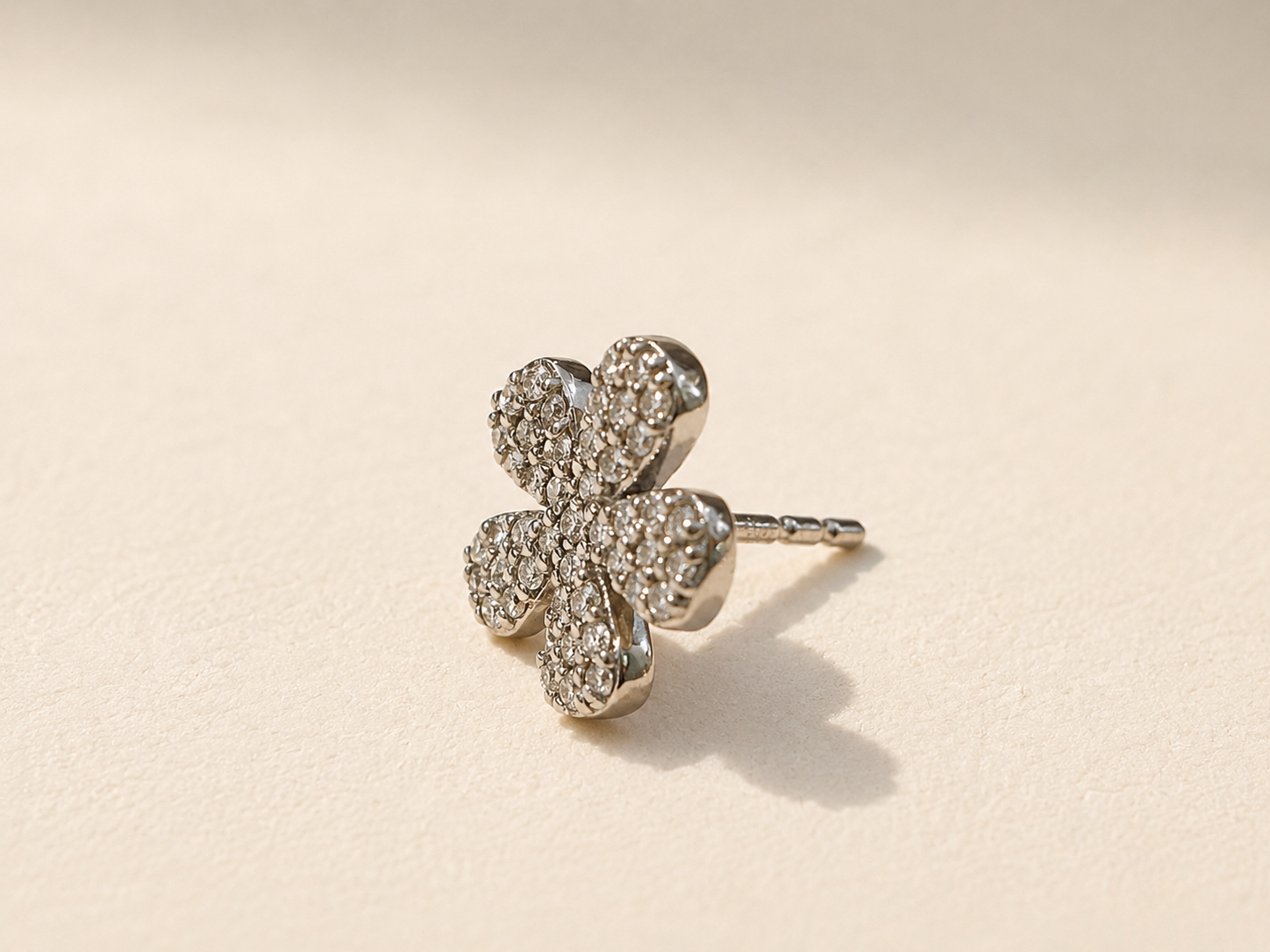Pave diamond flower stud earring with five petal design and silver tone setting