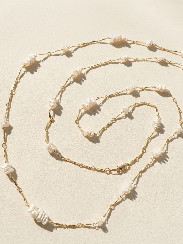 Gold-tone necklace with keshi pearls and linked drops, shown in three lengths
