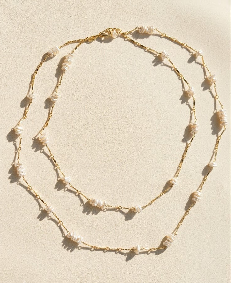 Gold-tone keshi pearl chain necklace with layered drape of shell drops