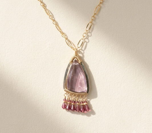 Gold fringe necklace with teardrop purple gemstone pendant and dangling plum tassels