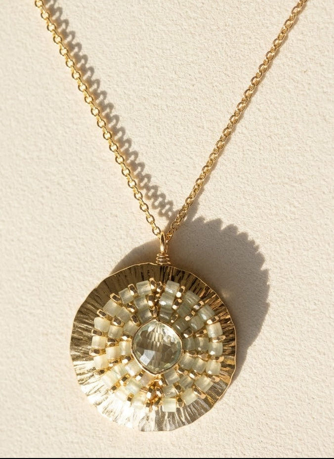 Gold-tone medallion necklace with round crystal pendant and beaded halo, short chain