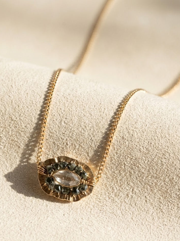 Gold medallion necklace with oval smoky centerpiece on chain