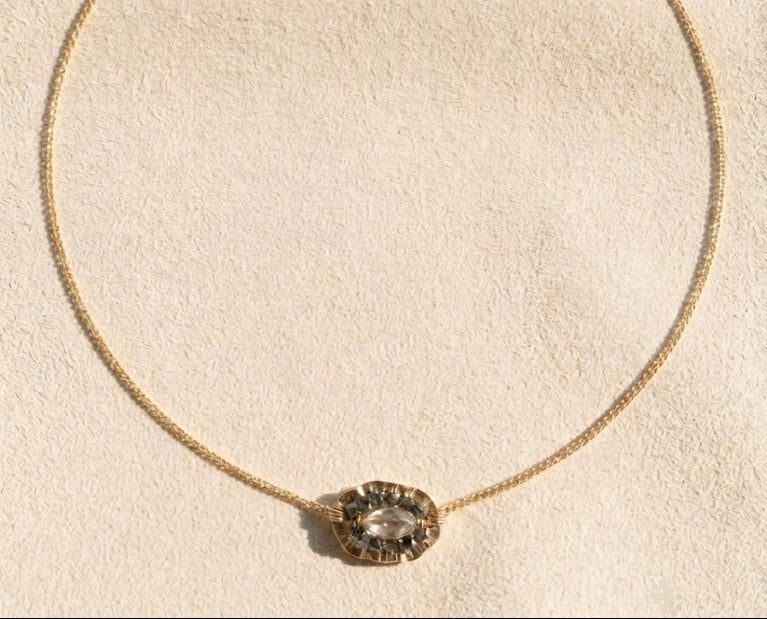Gold chain medallion necklace with oval bezel-set centerpiece