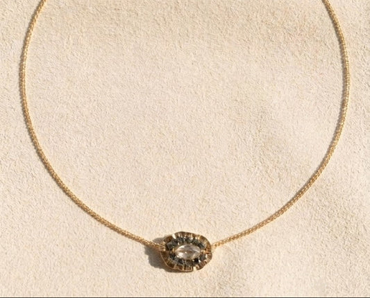 Gold chain medallion necklace with oval bezel-set centerpiece