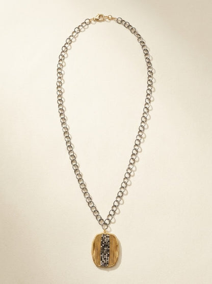 Oval pendant necklace with silver chain and gold-and-dark vertical striped oval medallion
