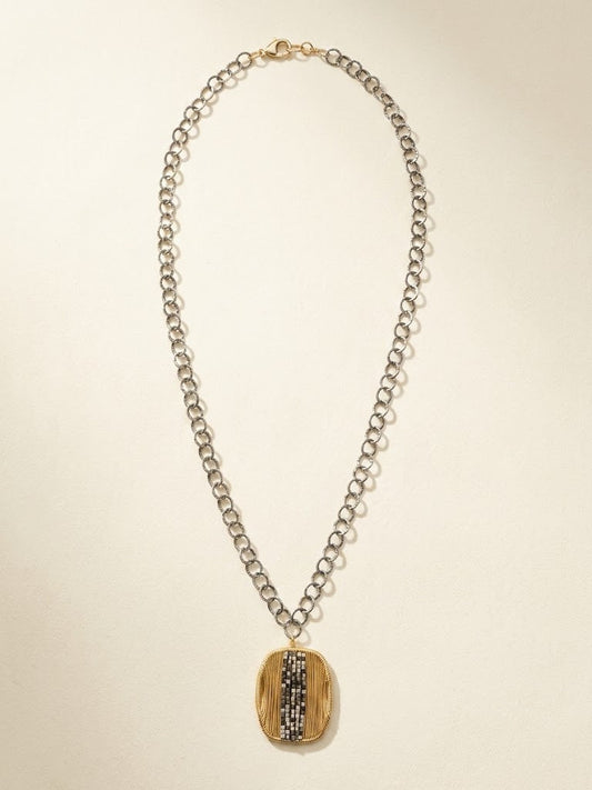 Oval pendant necklace with silver chain and gold-and-dark vertical striped oval medallion