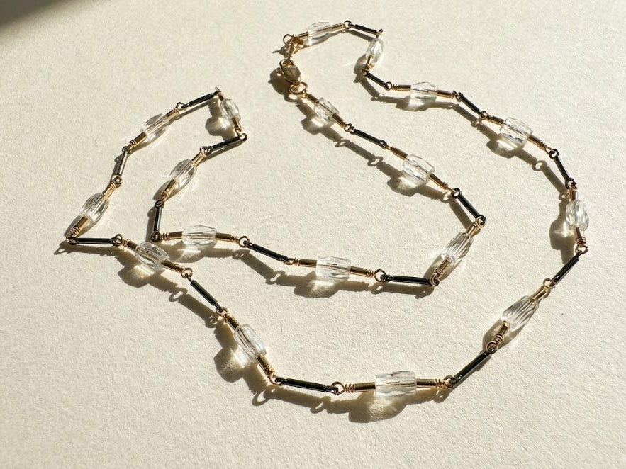 Two-tone crystal choker with clear and dark faceted beads on metal chain