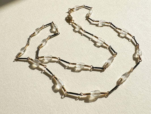 Two-tone crystal choker with clear and dark faceted beads on metal chain
