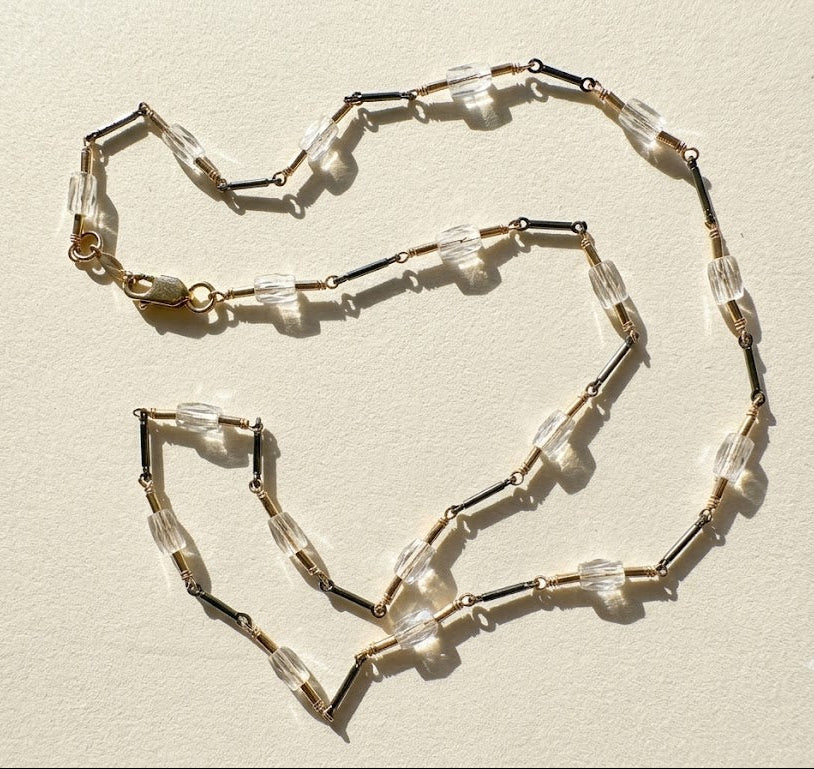 Two-tone crystal choker with clear rectangular crystals, dark beads, and clasp detail
