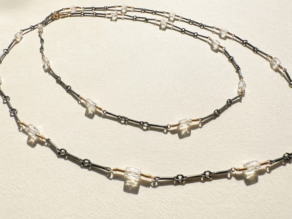 Long two-tone crystal chain necklace with layered silver and dark links