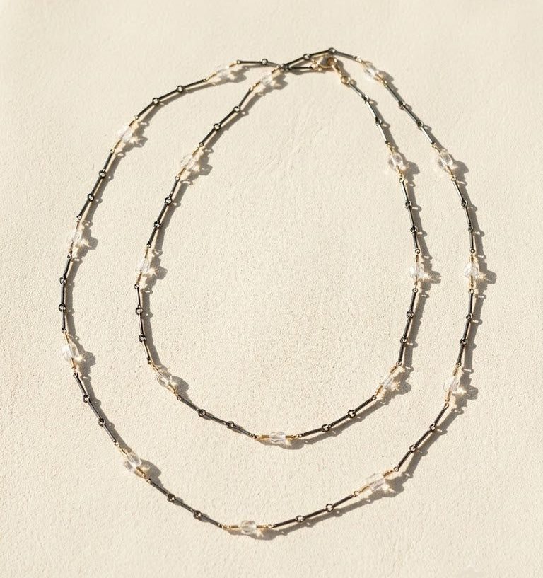 Long two-tone crystal chain necklace with layered double rows of crystal and dark links