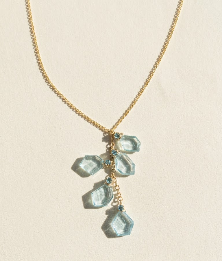 Aqua slice lariat necklace with gold chain and teal faceted charm cluster
