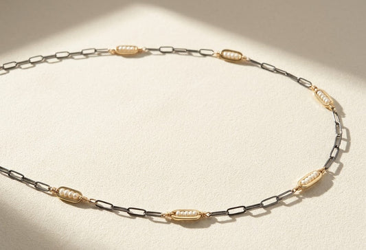 Two-tone seed pearl necklace with alternating metal links and oval pearl stations
