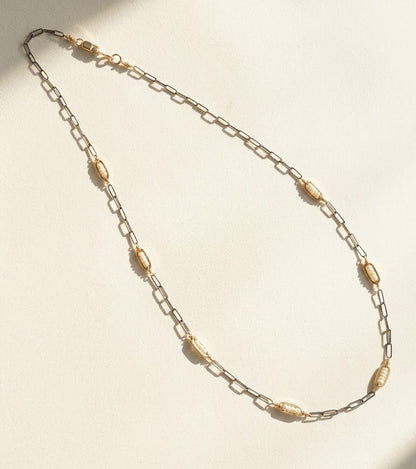 Two-tone seed pearl necklace with oval bead stations on linked metal chain