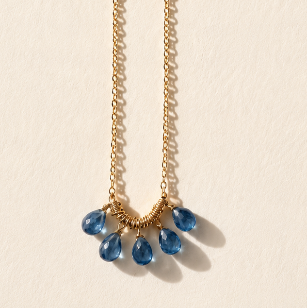 Gold-tone briolette necklace with blue teardrop gemstones