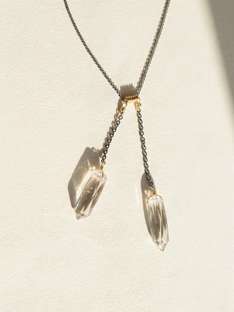 Two-tone crystal quartz lariat necklace with two dangling faceted crystals and gold accents