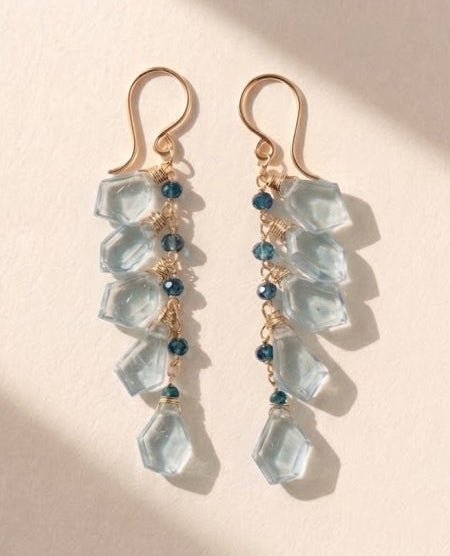Gold-tone drop earrings with aqua blue faceted cubes and dark blue bead accents