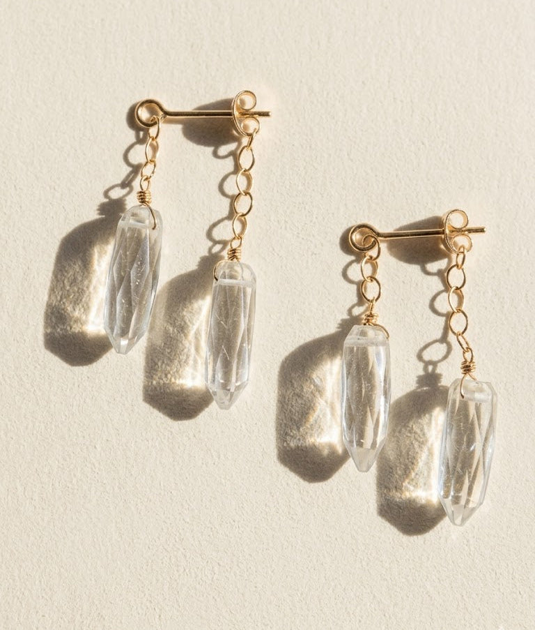 Gold-tone dagger crystal drop earrings with clear faceted prisms and chain links