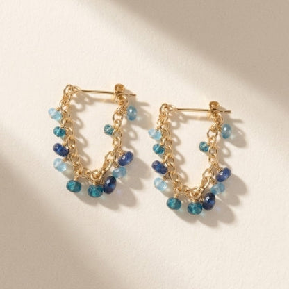 Gold chain hoop earrings with mixed blue and teal bead drops