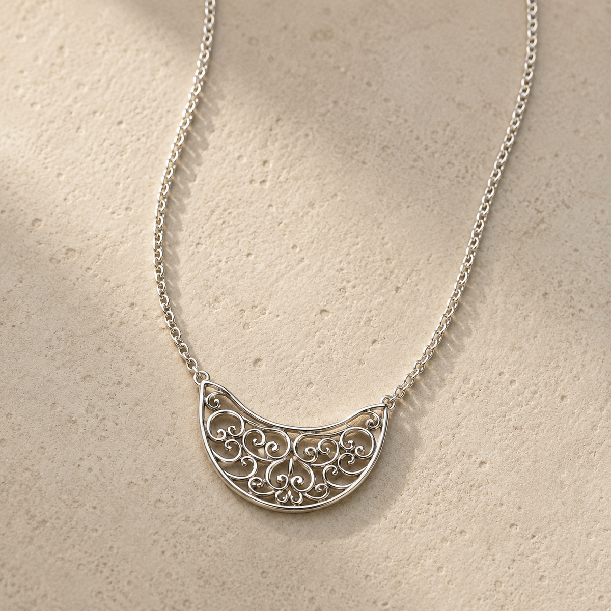 Silver filigree crescent necklace with link chain and ornate half-moon pendant