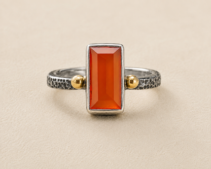 Carnelian orange stone ring with textured silver band and gold side accents