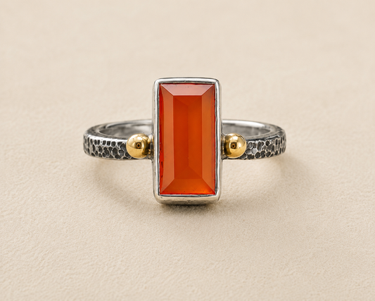 Carnelian orange stone ring with textured silver band and gold side accents
