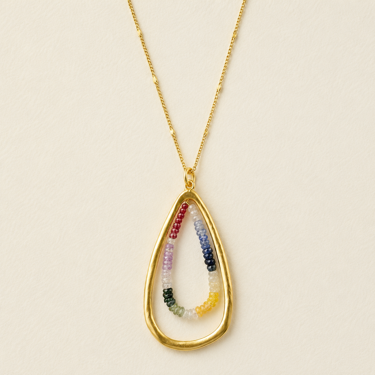 Gold teardrop necklace with multicolor sapphire-style bead pendant on chain