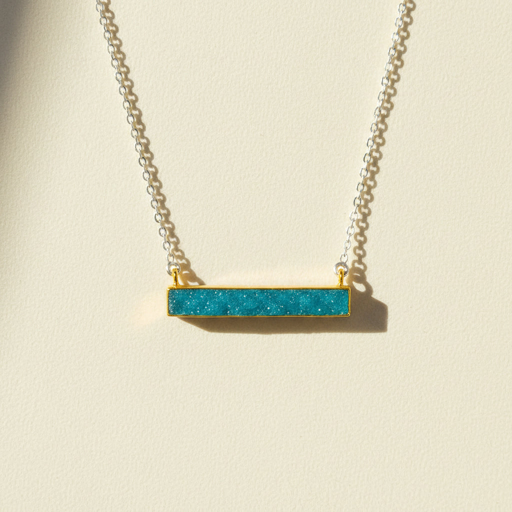 Two-tone druzy bar necklace with aqua blue rectangular pendant on gold chain