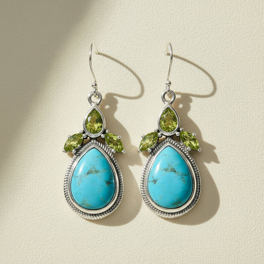 Turquoise teardrop gemstone drop earrings with peridot green accents and silver-tone frames