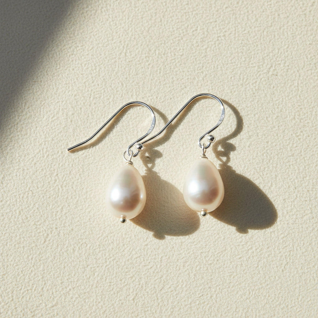Pearl drop earrings on a white background
