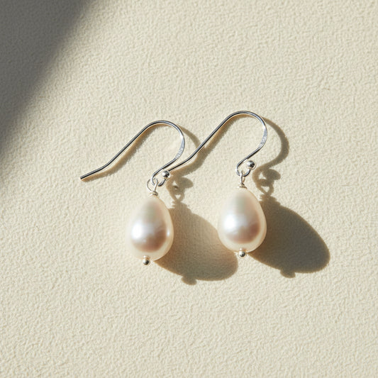 Pearl drop earrings on a white background