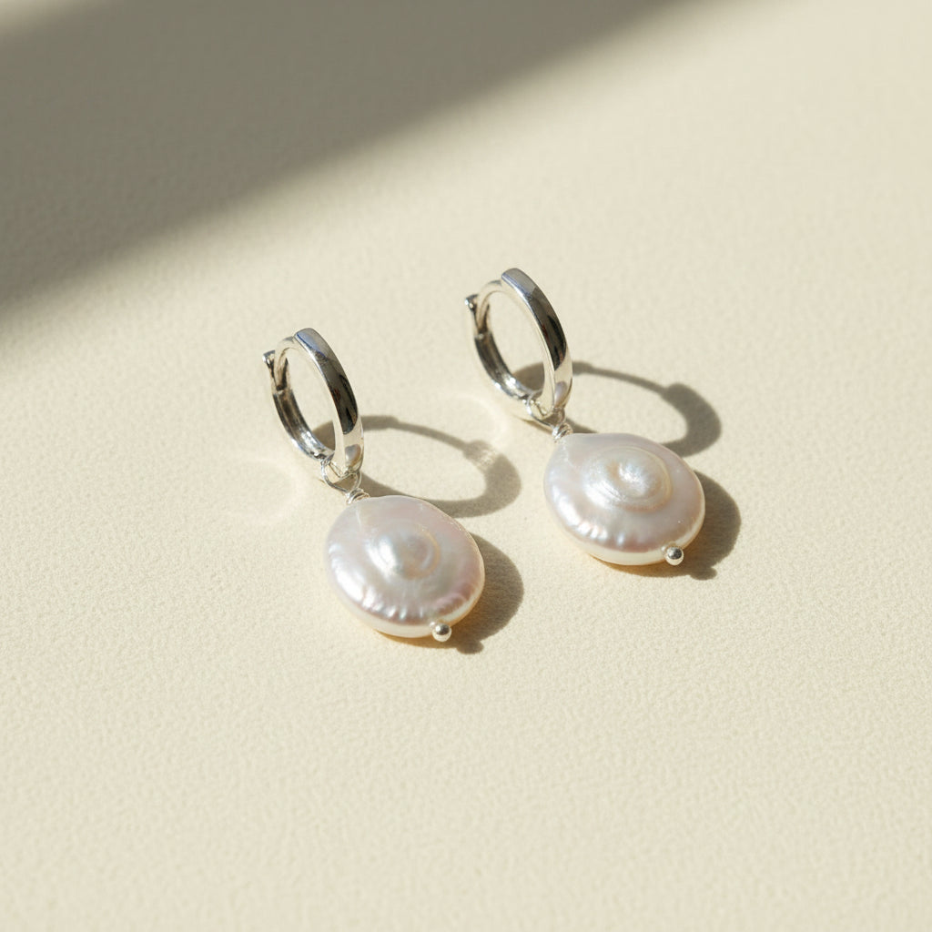Pair of pearl earrings on a white background