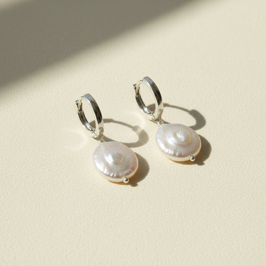Pair of pearl earrings on a white background