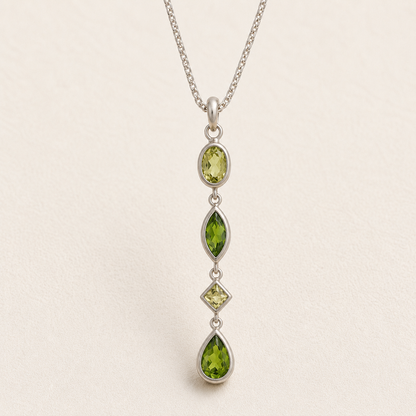 Gemstone drop necklace with four green faceted marquise pendants on silver chain