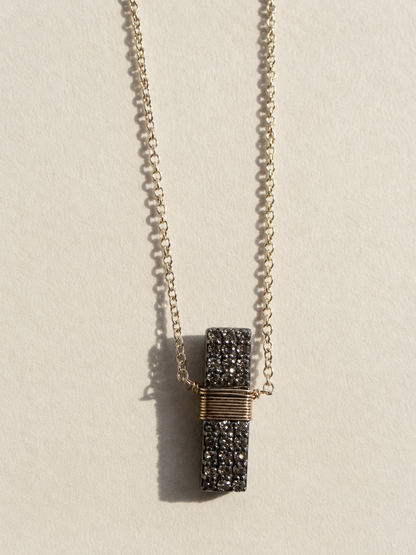 Pavé diamond bar necklace with gold chain and wrapped rectangular pendant