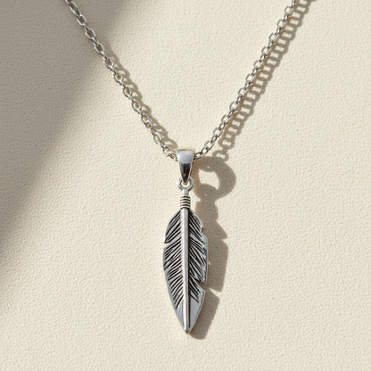Oxidized feather pendant necklace with silver-tone chain, hanging feather charm center