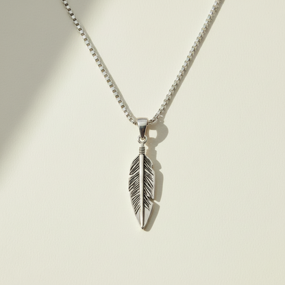 Oxidized feather pendant necklace with silver-tone feather charm, front view
