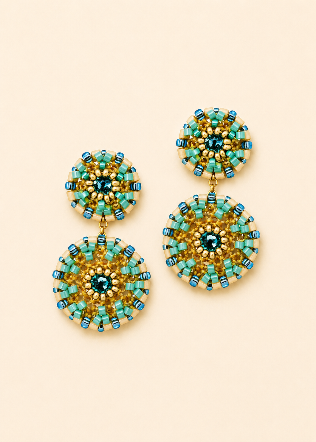 Beaded drop earrings with teal and gold double-circle design and central blue gem